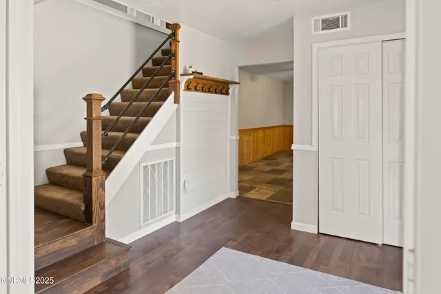 a view of entryway and hall with wooden floor