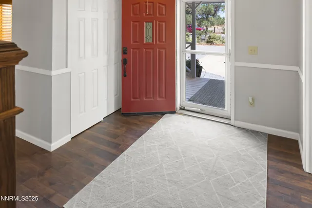 an empty room with windows bathroom and entrance