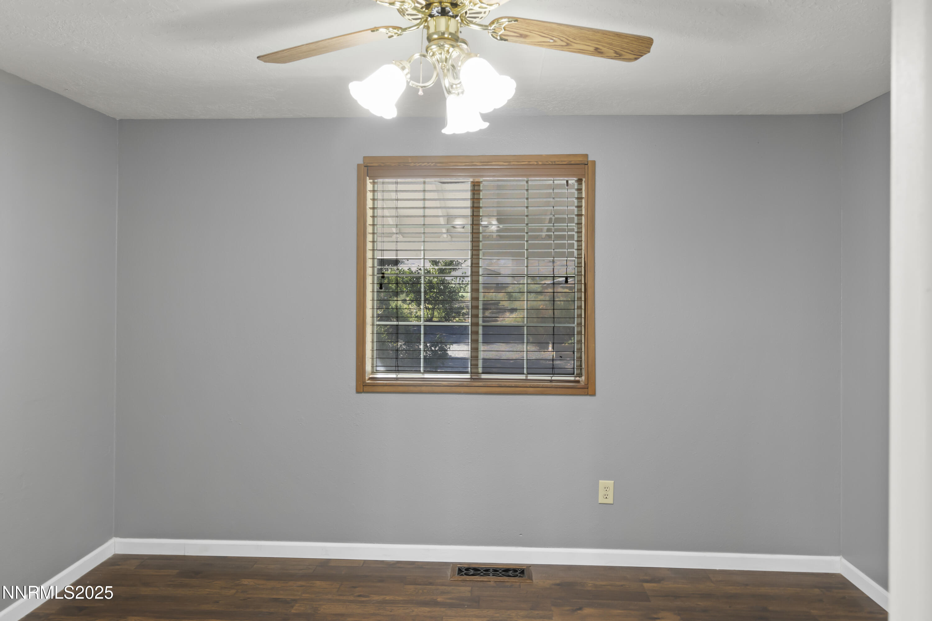 1165 Farm Lane Fernley, NV 89408 - Photo 10 of 38 a view of an empty room with wooden floor and a window