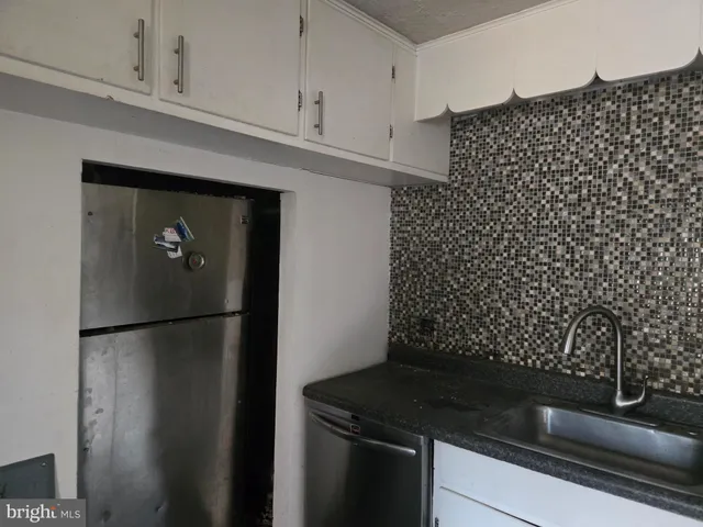a kitchen with a refrigerator and a stove