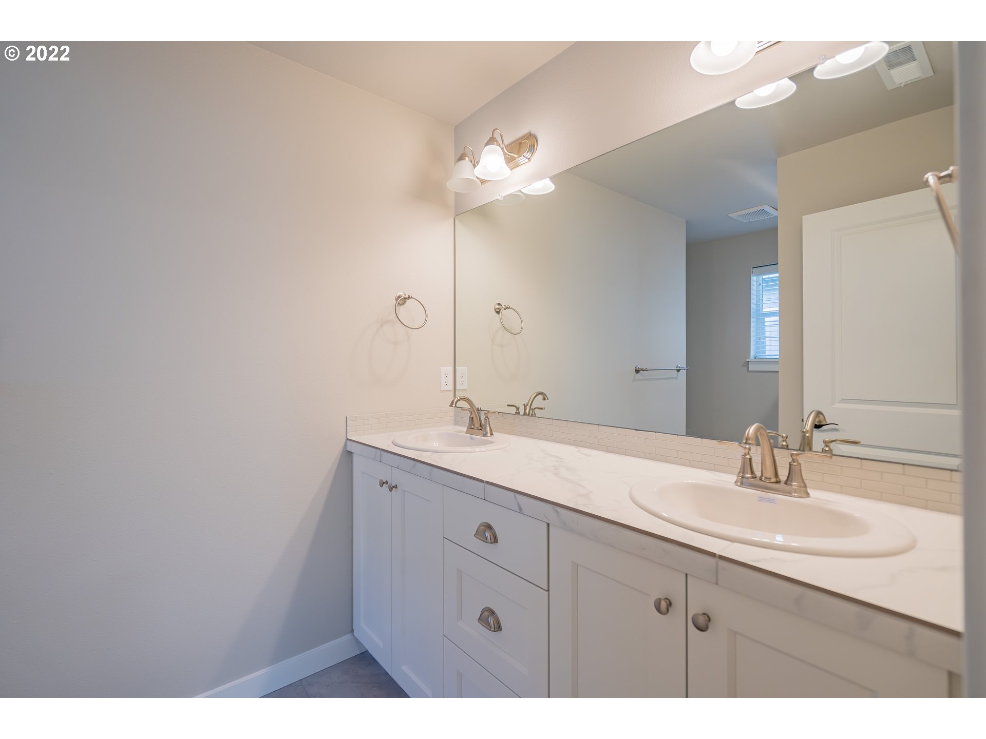 7225 South 13th Street Ridgefield, WA 98642 - Photo 15 of 30 a bathroom with a double vanity sink and a mirror