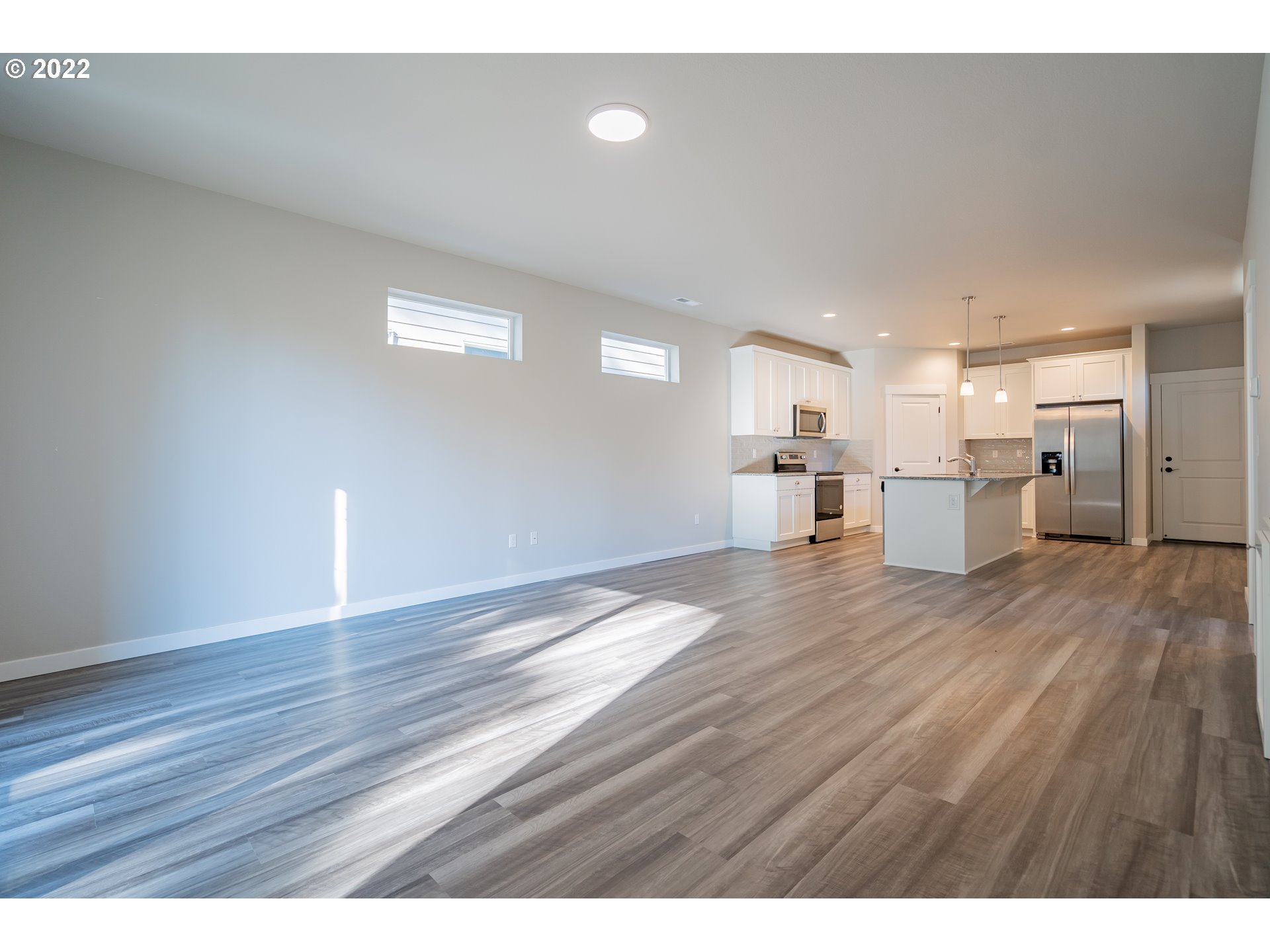 7225 South 13th Street Ridgefield, WA 98642 - Photo 5 of 30 a view of a kitchen with a counter space and wooden floor