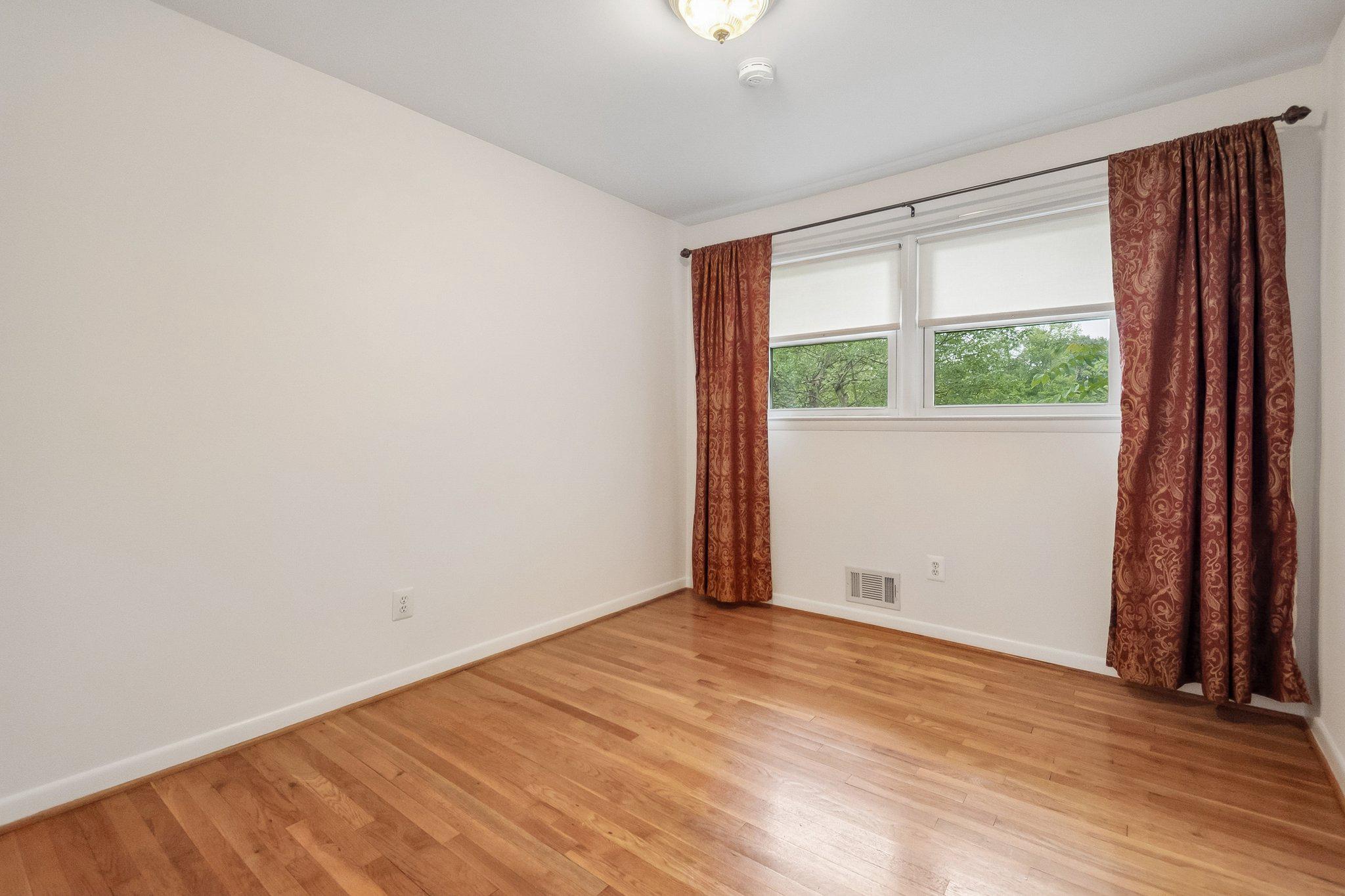 2807 Hathaway Terrace Silver Spring, MD 20906 - Photo 9 of 20 an empty room with wooden floor and windows