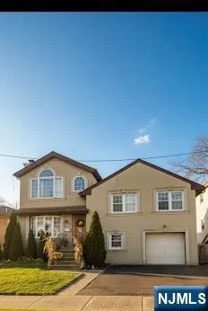 a view of a big house with wooden fence