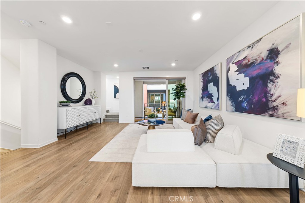171 Cadence Irvine, CA 92618 - Photo 15 of 27 a living room with furniture a large window and wooden floor