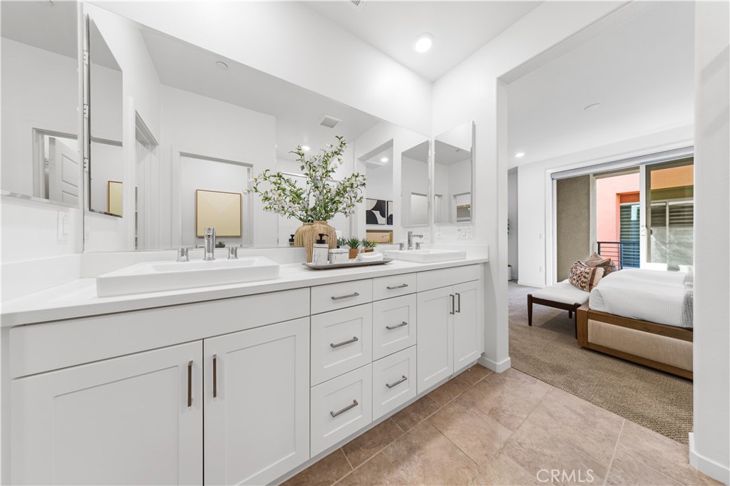 171 Cadence Irvine, CA 92618 - Photo 19 of 27 a spacious en suite bathroom with double sink and a large mirror