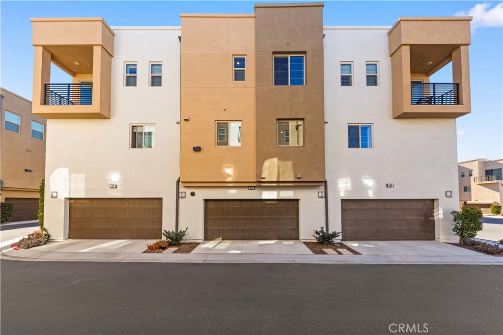171 Cadence Irvine, CA 92618 - Photo 2 of 27 a front view of a house with a yard and garage