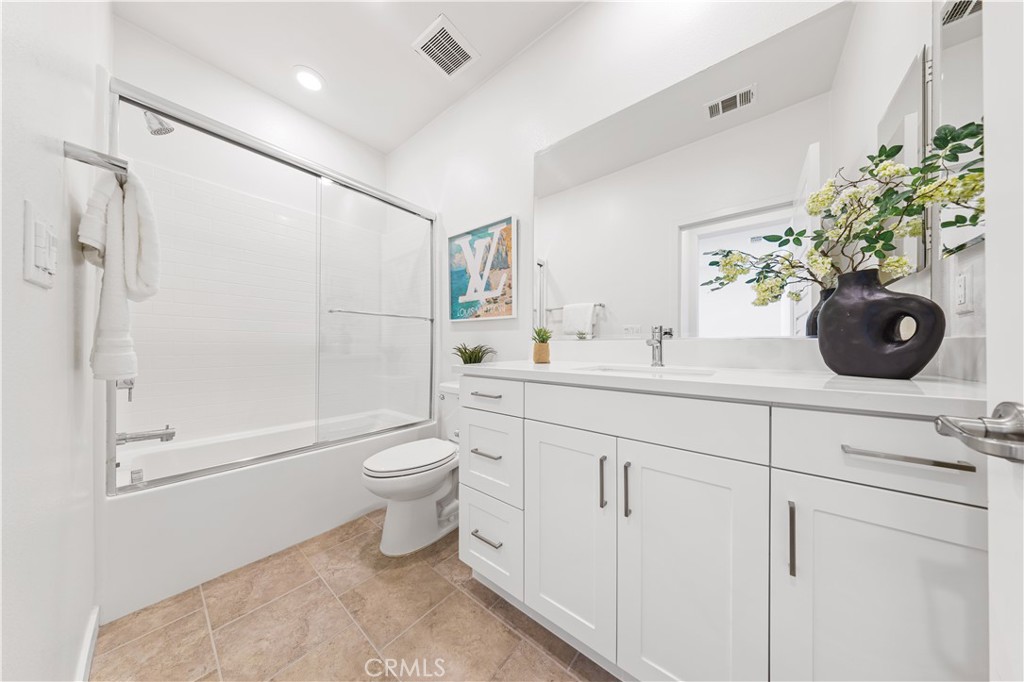 171 Cadence Irvine, CA 92618 - Photo 21 of 27 a bathroom with a double vanity sink toilet and shower