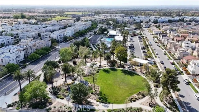 an aerial view of residential houses with outdoor space and swimming pool