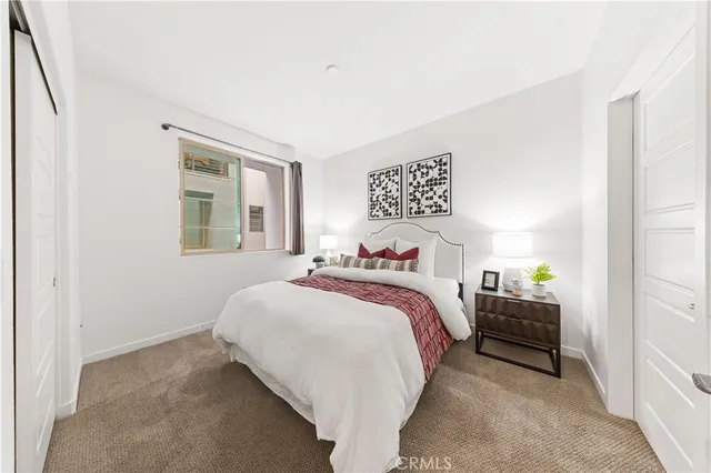 a bedroom with bed and window