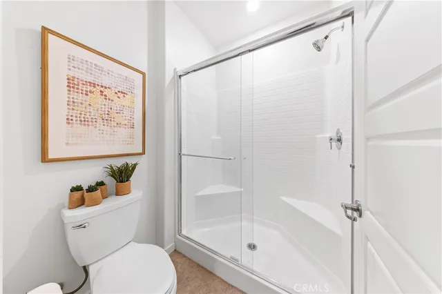 a white toilet sitting next to a bath tub shower