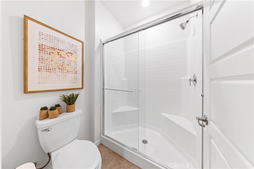 171 Cadence Irvine, CA 92618 - Photo 7 of 27 a white toilet sitting next to a bath tub shower