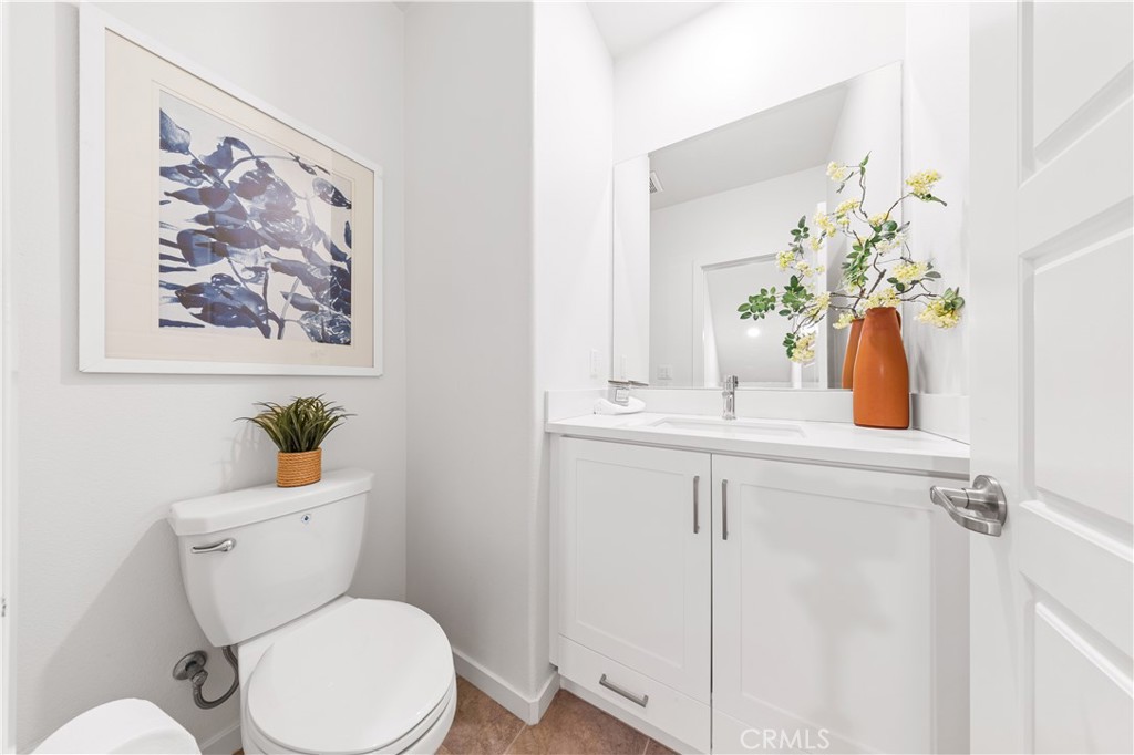 171 Cadence Irvine, CA 92618 - Photo 9 of 27 a bathroom with a toilet sink and mirror