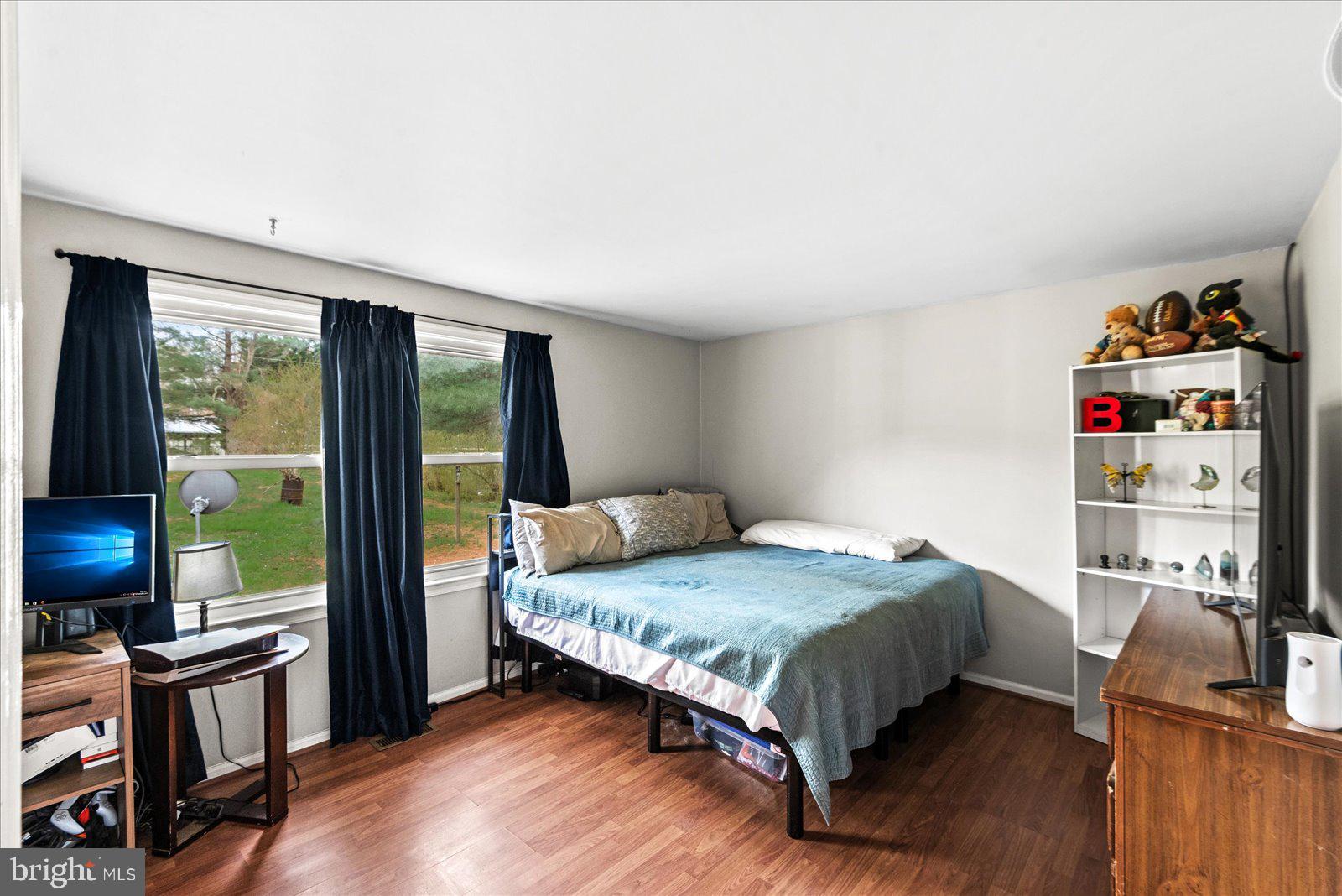 8441 Pamunkey Road Spotsylvania, VA 22551 - Photo 13 of 32 a bedroom with a bed flat screen tv and a large window
