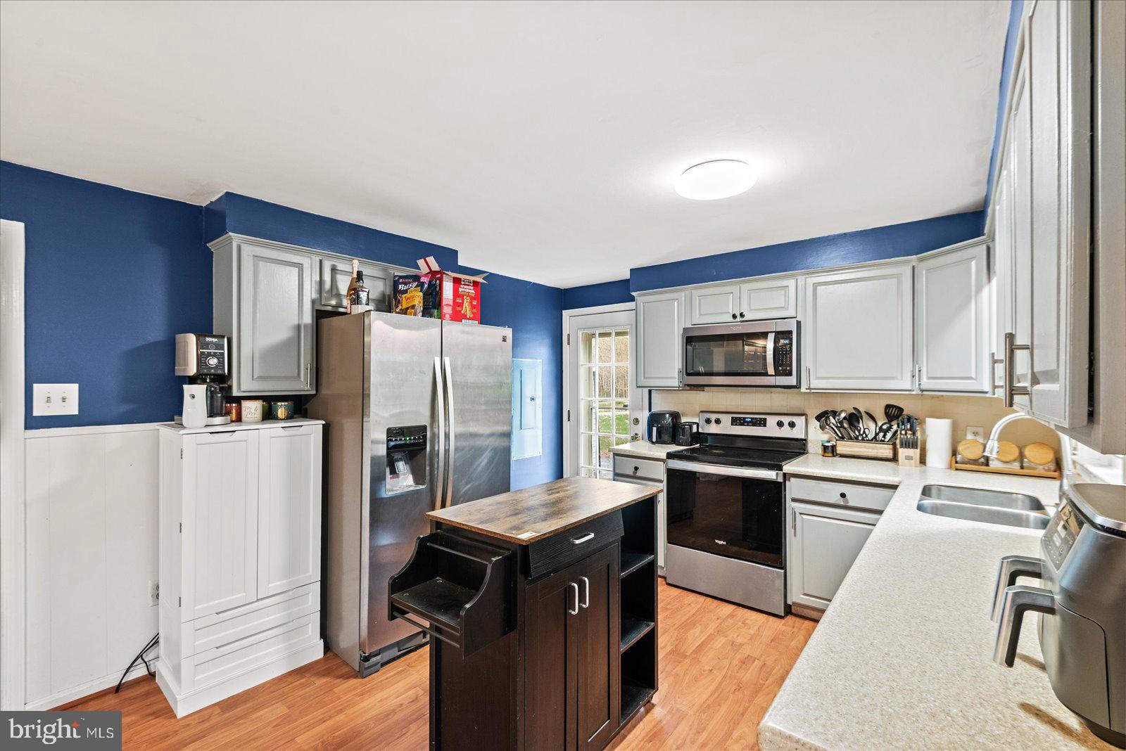 8441 Pamunkey Road Spotsylvania, VA 22551 - Photo 4 of 32 a kitchen with stainless steel appliances granite countertop a refrigerator stove and sink