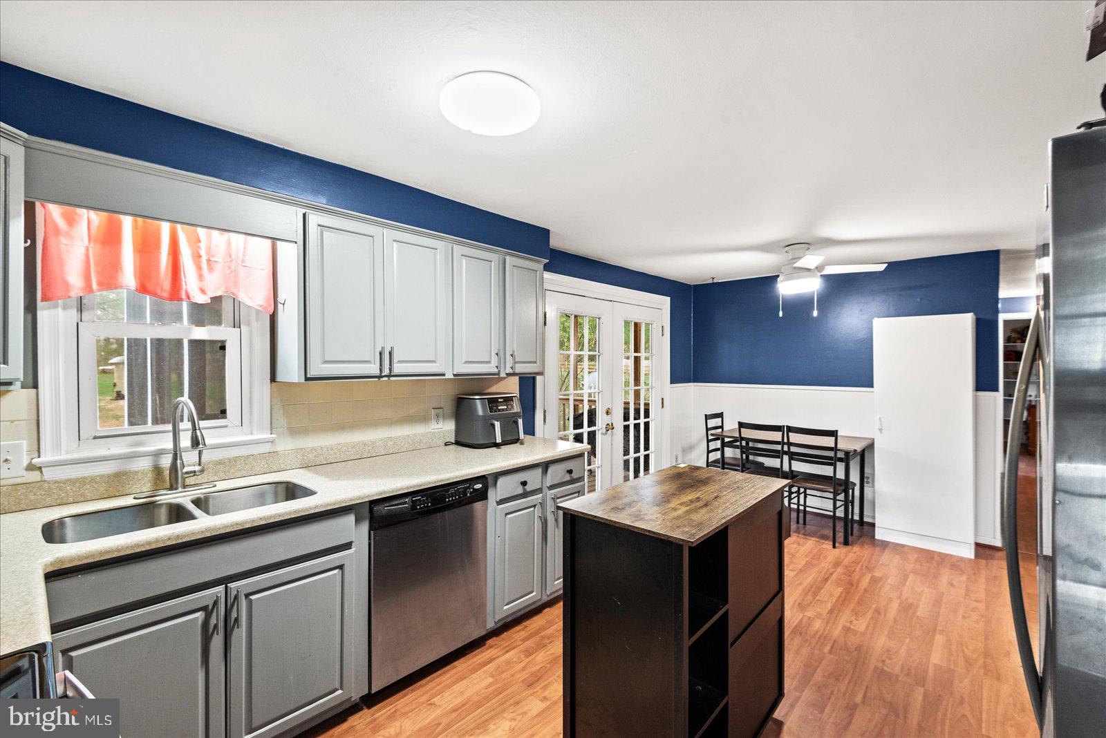 8441 Pamunkey Road Spotsylvania, VA 22551 - Photo 5 of 32 a kitchen with stainless steel appliances granite countertop a sink stove and refrigerator