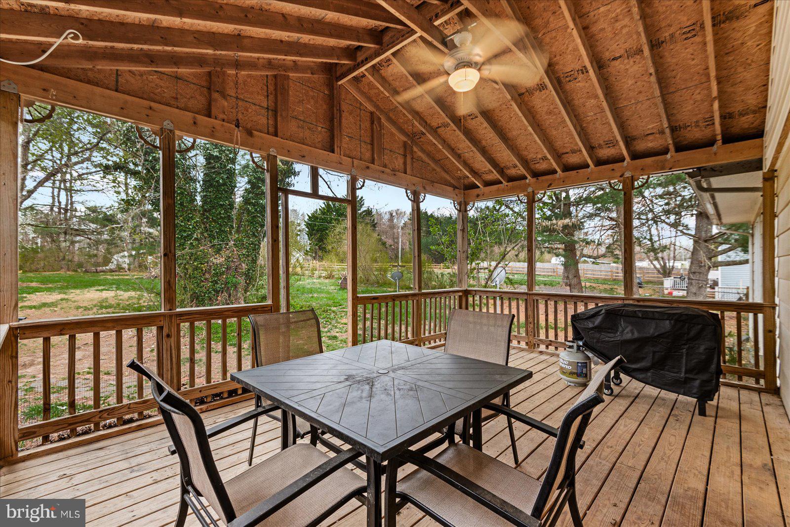 8441 Pamunkey Road Spotsylvania, VA 22551 - Photo 8 of 32 a view of a balcony with furniture and wooden floor