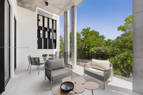 a balcony with furniture and a potted plant