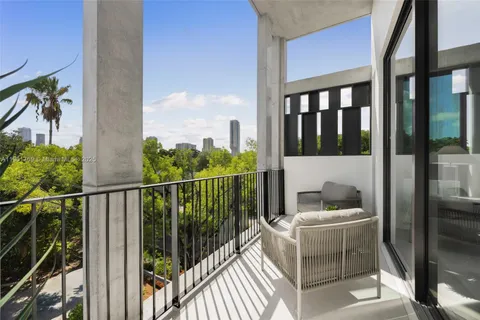 a view of a balcony with furniture