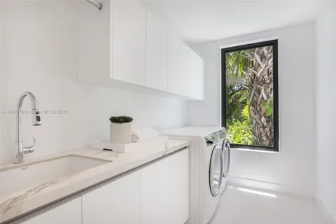 a bathroom with a granite countertop sink and a window
