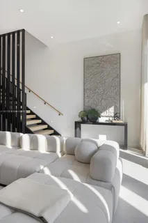a living room with furniture and a potted plant