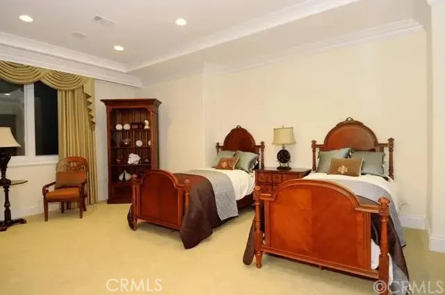 a spacious bedroom with two beds and a desk