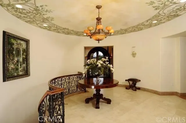 a view of a workspace with furniture and a chandelier