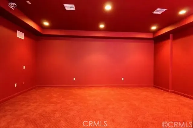 a view of empty room with yellow lighting