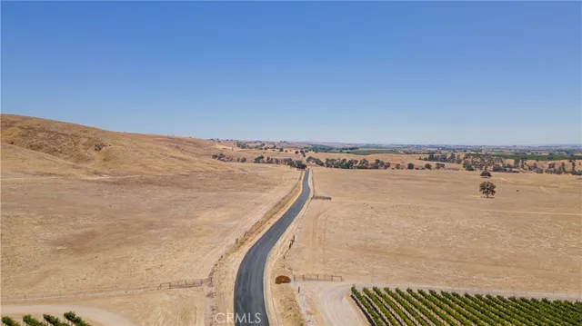a view of a dry yard with a mountain in the background