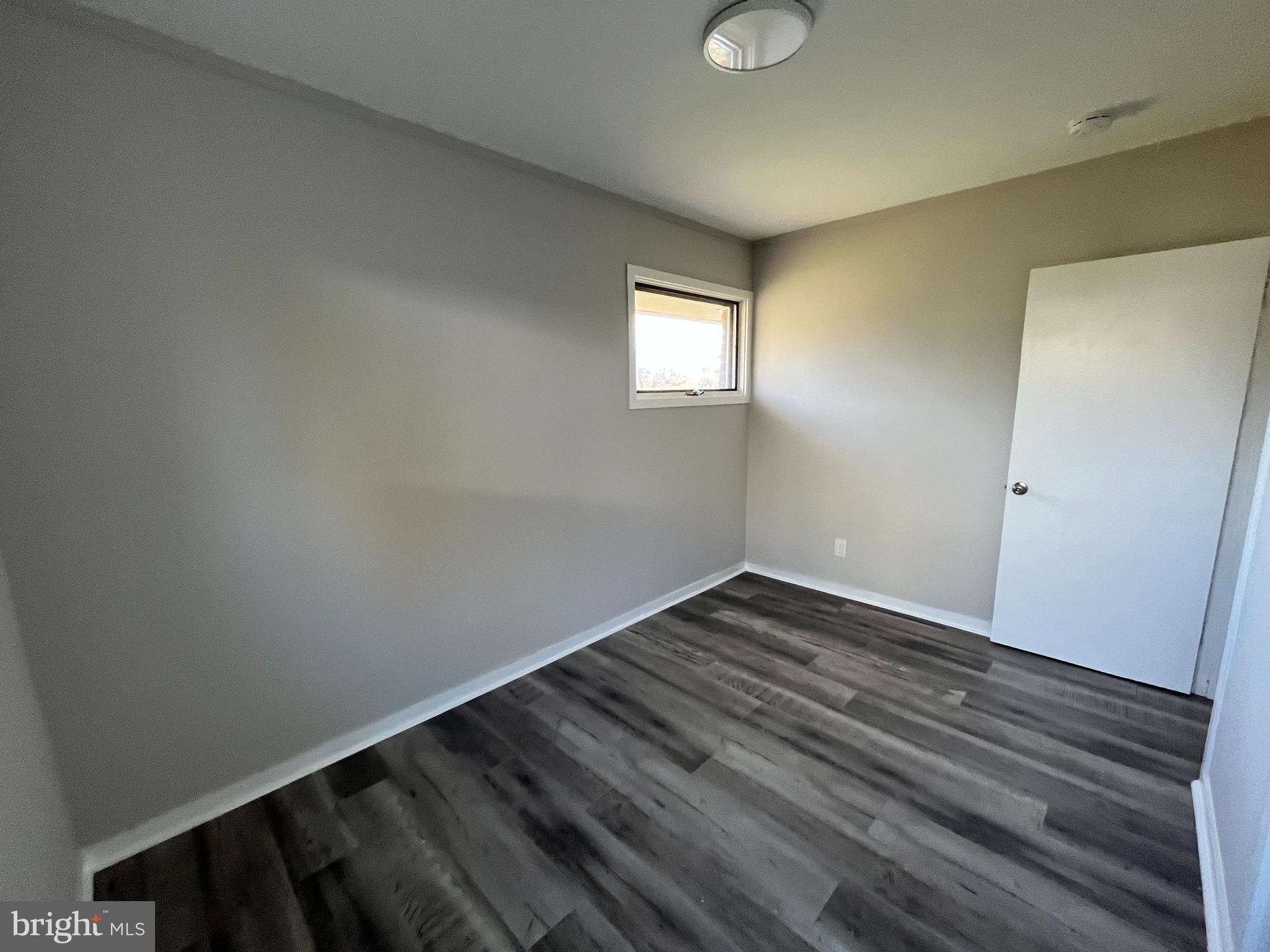 9106 Verree Road Philadelphia, PA 19115 - Photo 38 of 64 a view of an empty room with wooden floor and a window