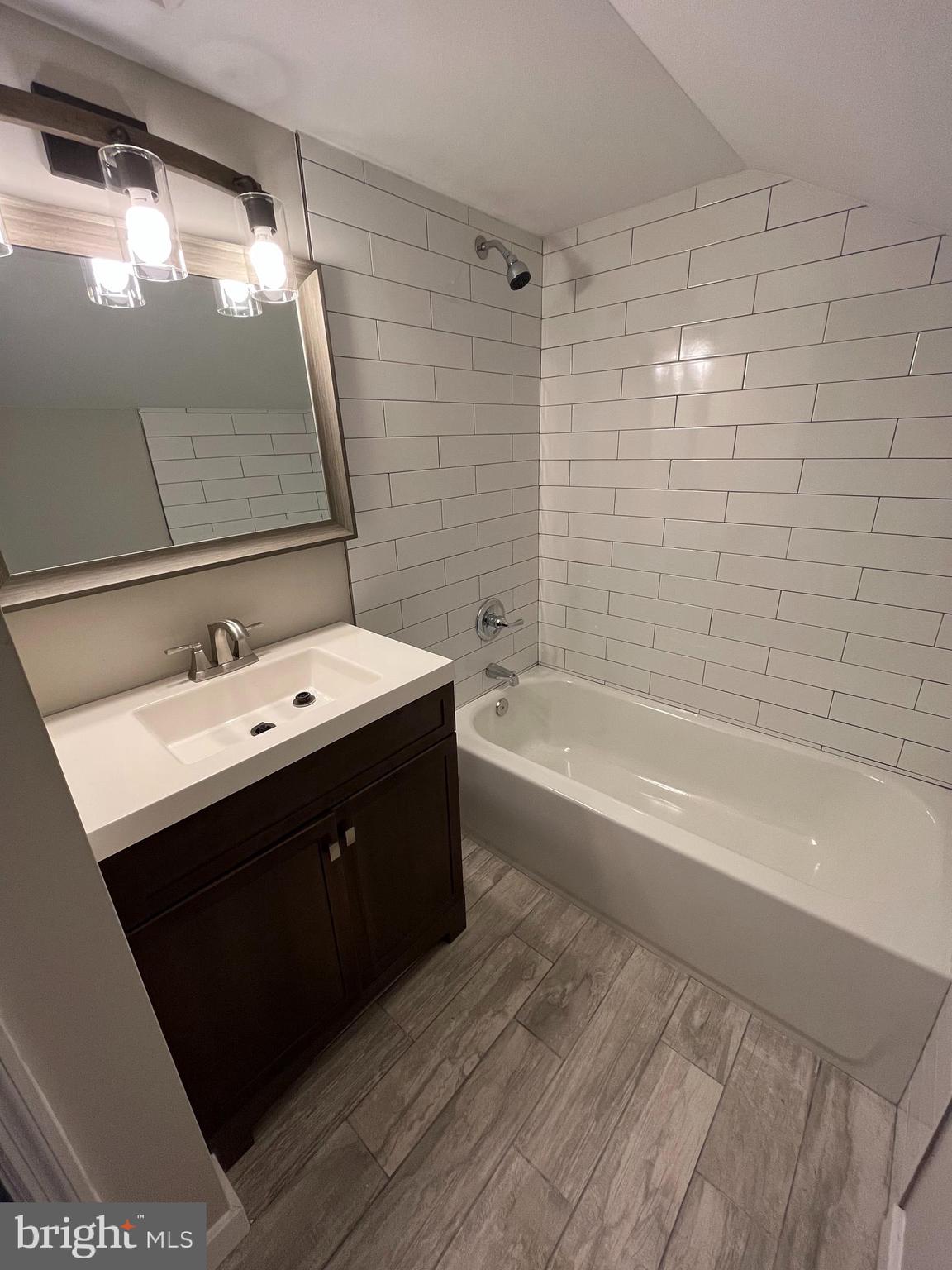 9106 Verree Road Philadelphia, PA 19115 - Photo 47 of 64 a bathroom with a sink a mirror and a bathtub