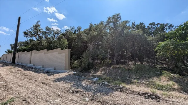 a view of a wooden fence and trees around