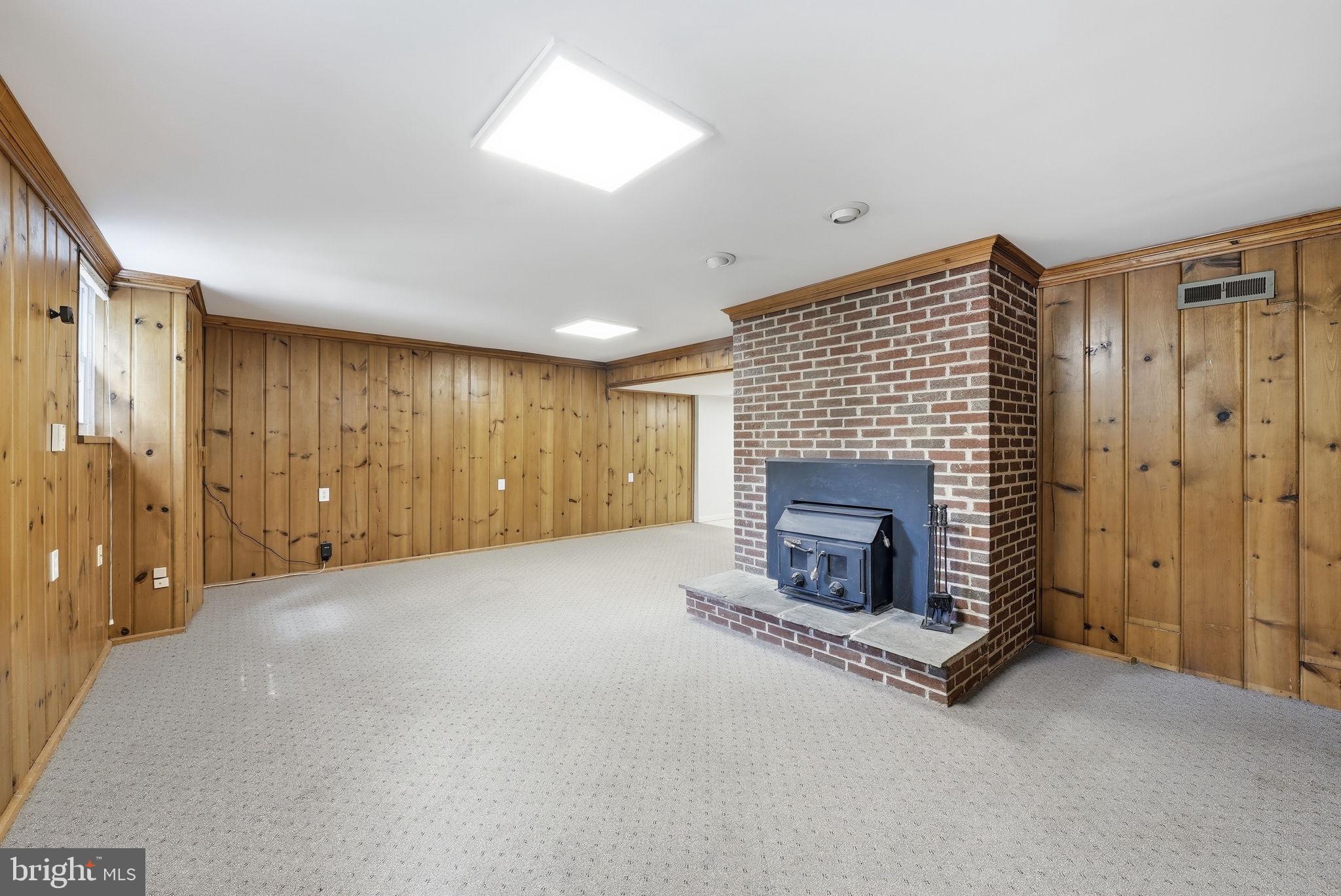 9425 Emory Grove Road Gaithersburg, MD 20877 - Photo 29 of 47 Woodburning fireplace insert and wood paneling