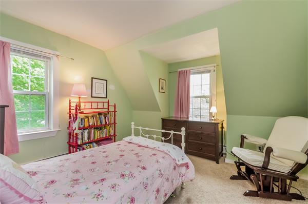 3 Revolutionary Road Lexington, MA 02421 - Photo 20 of 29 a bedroom with a bed a table and a window