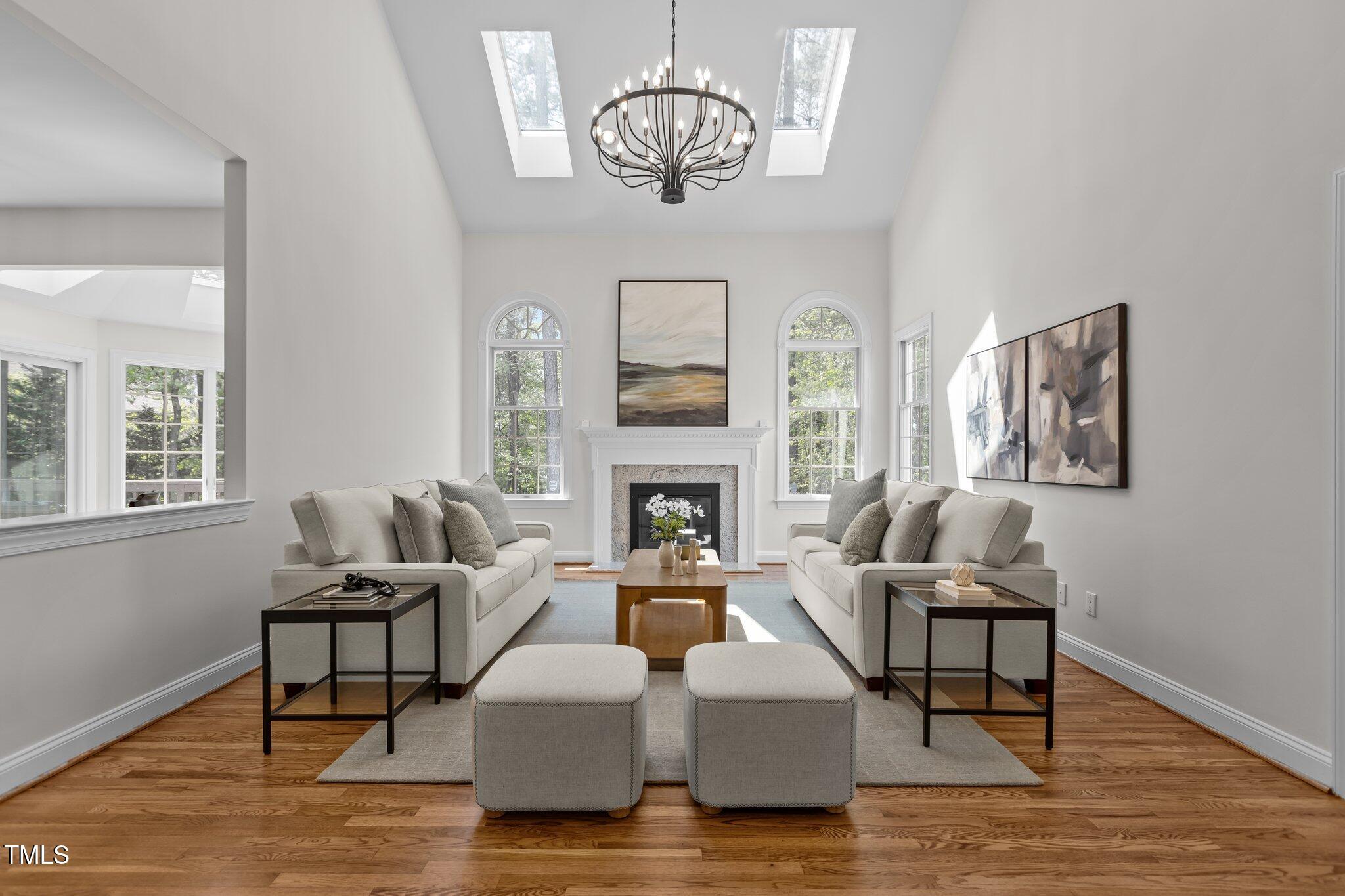 103 Ticonderoga Road Cary, NC 27519 - Photo 8 of 65 a living room with furniture chandelier and a fireplace
