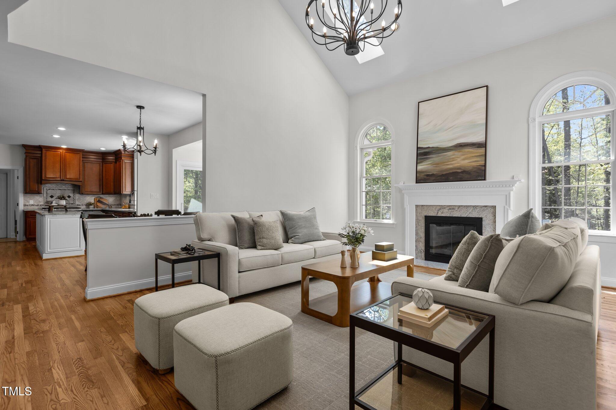 103 Ticonderoga Road Cary, NC 27519 - Photo 9 of 65 a living room with furniture a fireplace and a flat screen tv