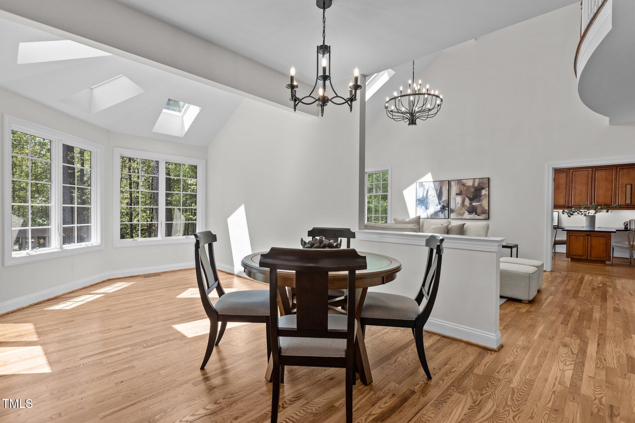 103 Ticonderoga Road Cary, NC 27519 - Photo 13 of 65 a view of a dining room with furniture a chandelier and wooden floor