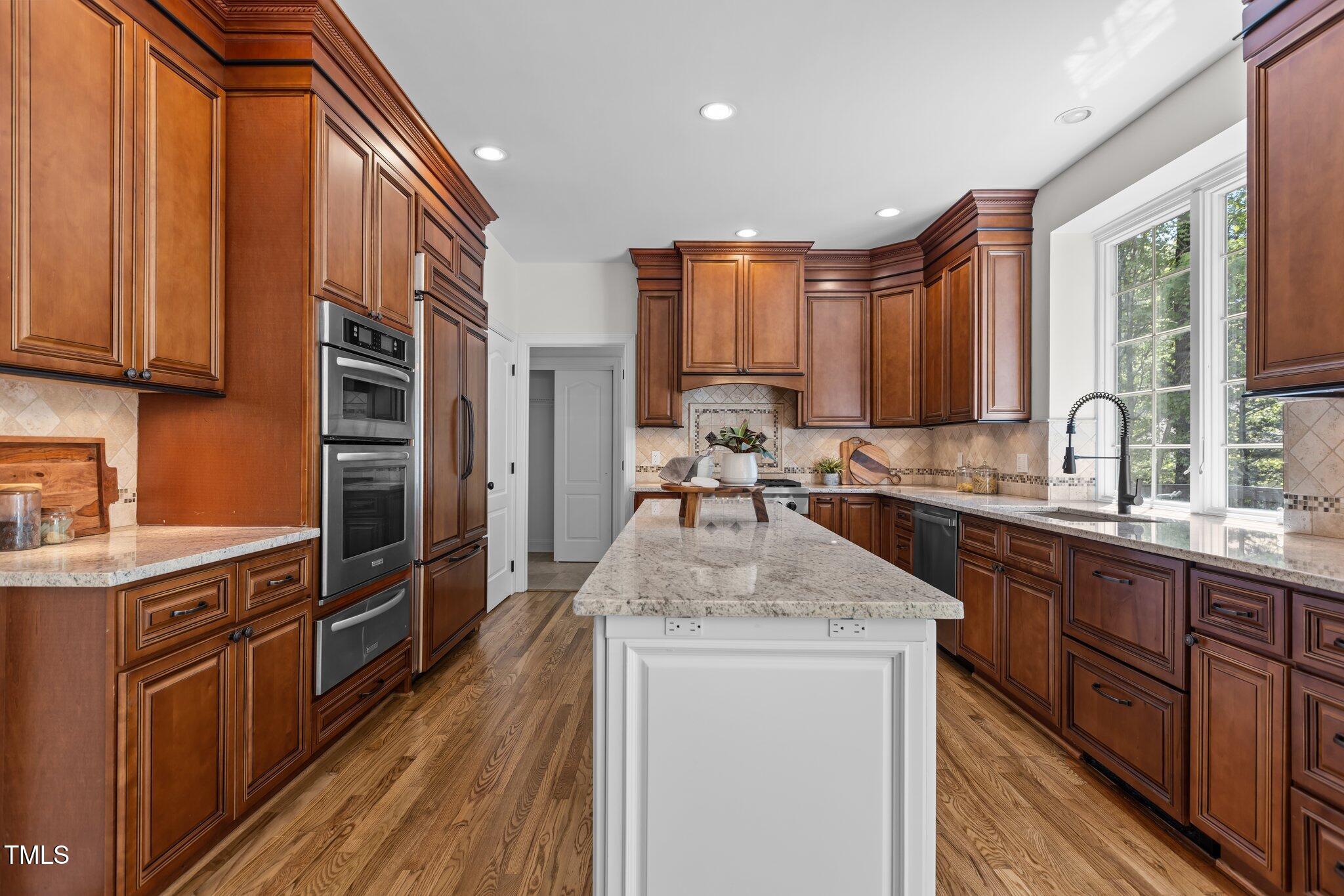 103 Ticonderoga Road Cary, NC 27519 - Photo 17 of 65 a kitchen with stainless steel appliances granite countertop a sink stove and refrigerator