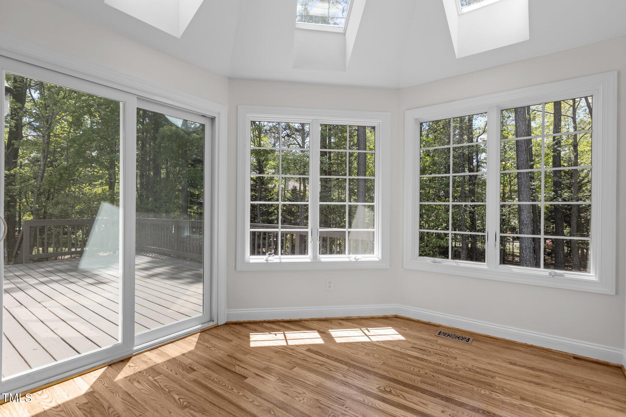 103 Ticonderoga Road Cary, NC 27519 - Photo 18 of 65 a view of an empty room with wooden floor and a window