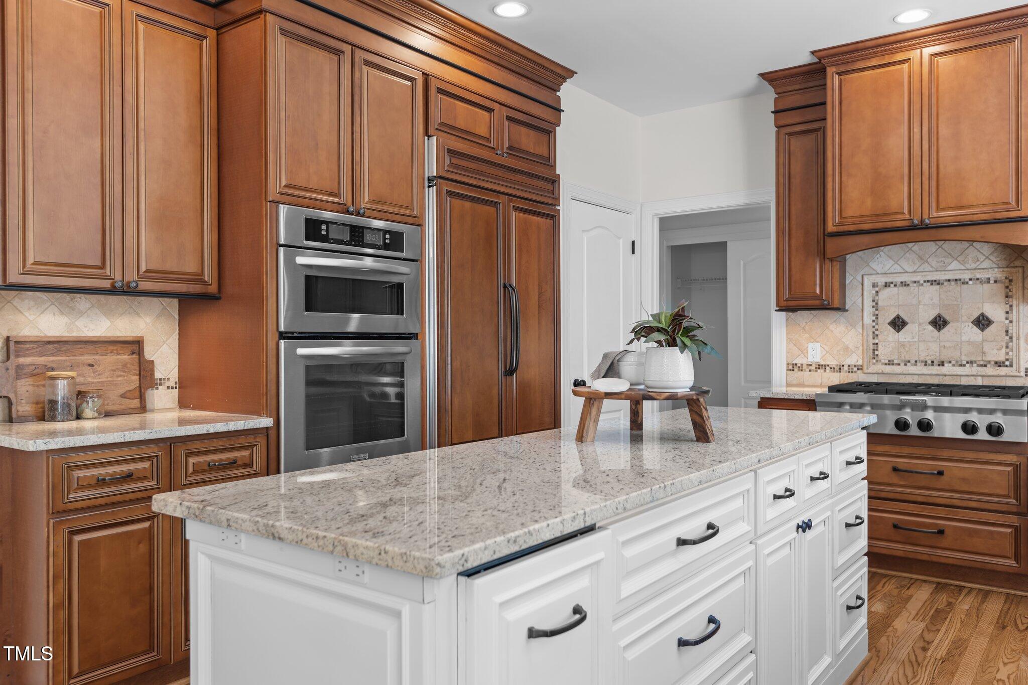 103 Ticonderoga Road Cary, NC 27519 - Photo 19 of 65 a kitchen with stainless steel appliances granite countertop a stove and cabinets