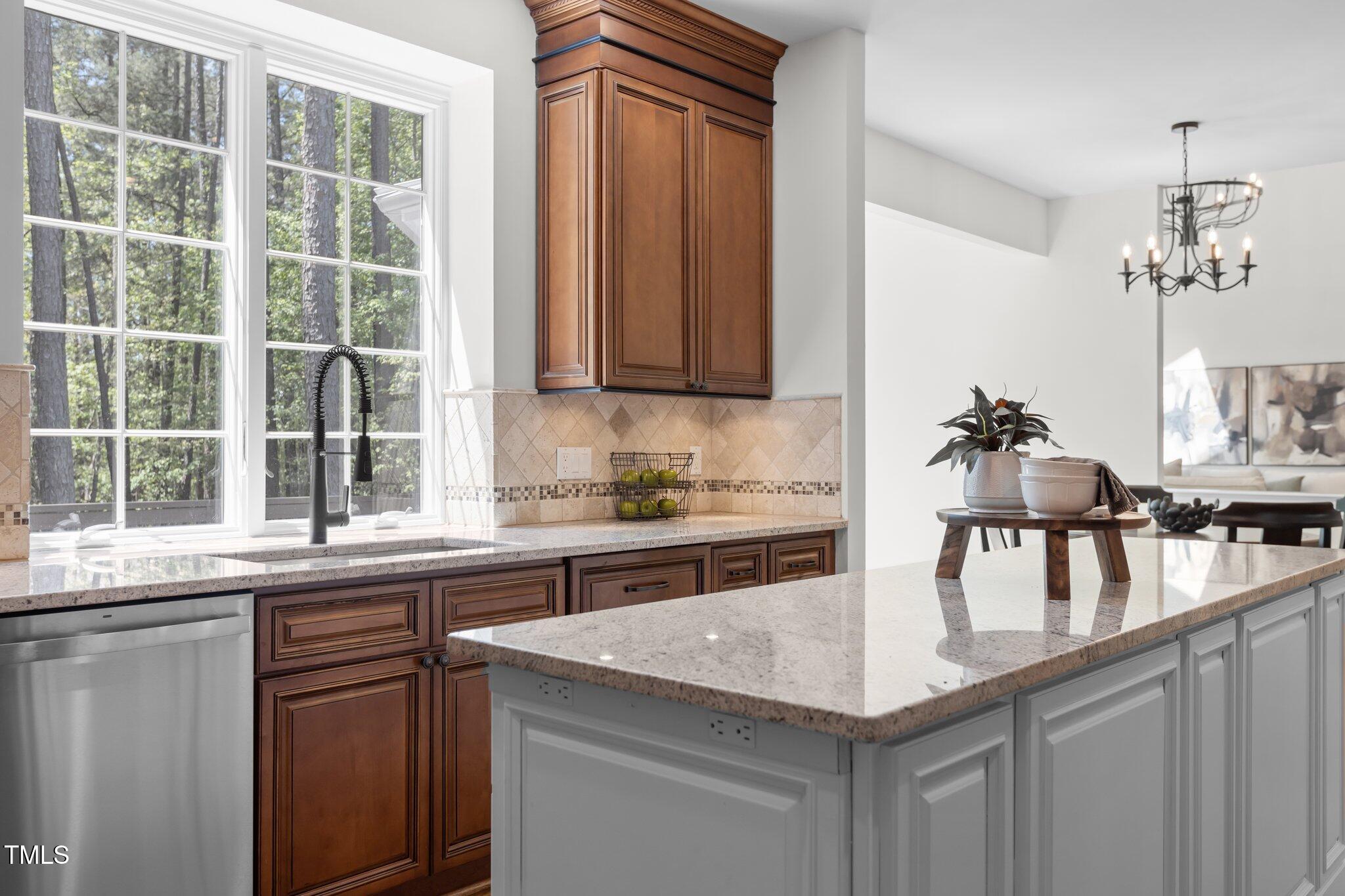 103 Ticonderoga Road Cary, NC 27519 - Photo 20 of 65 a kitchen with kitchen island granite countertop a sink and a window