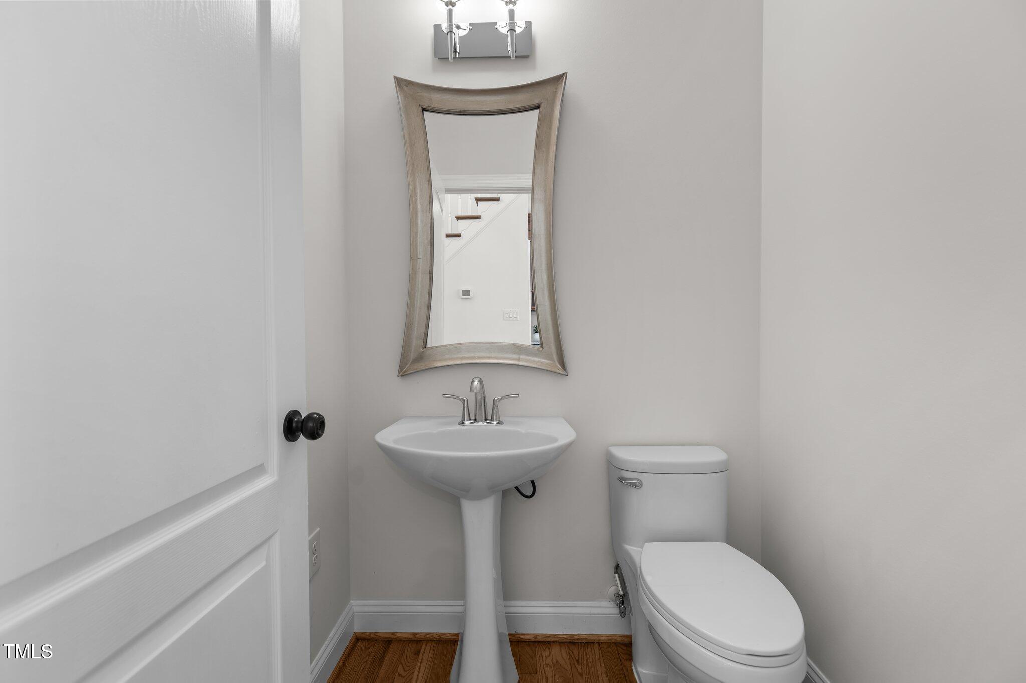 103 Ticonderoga Road Cary, NC 27519 - Photo 22 of 65 a bathroom with a toilet sink and mirror