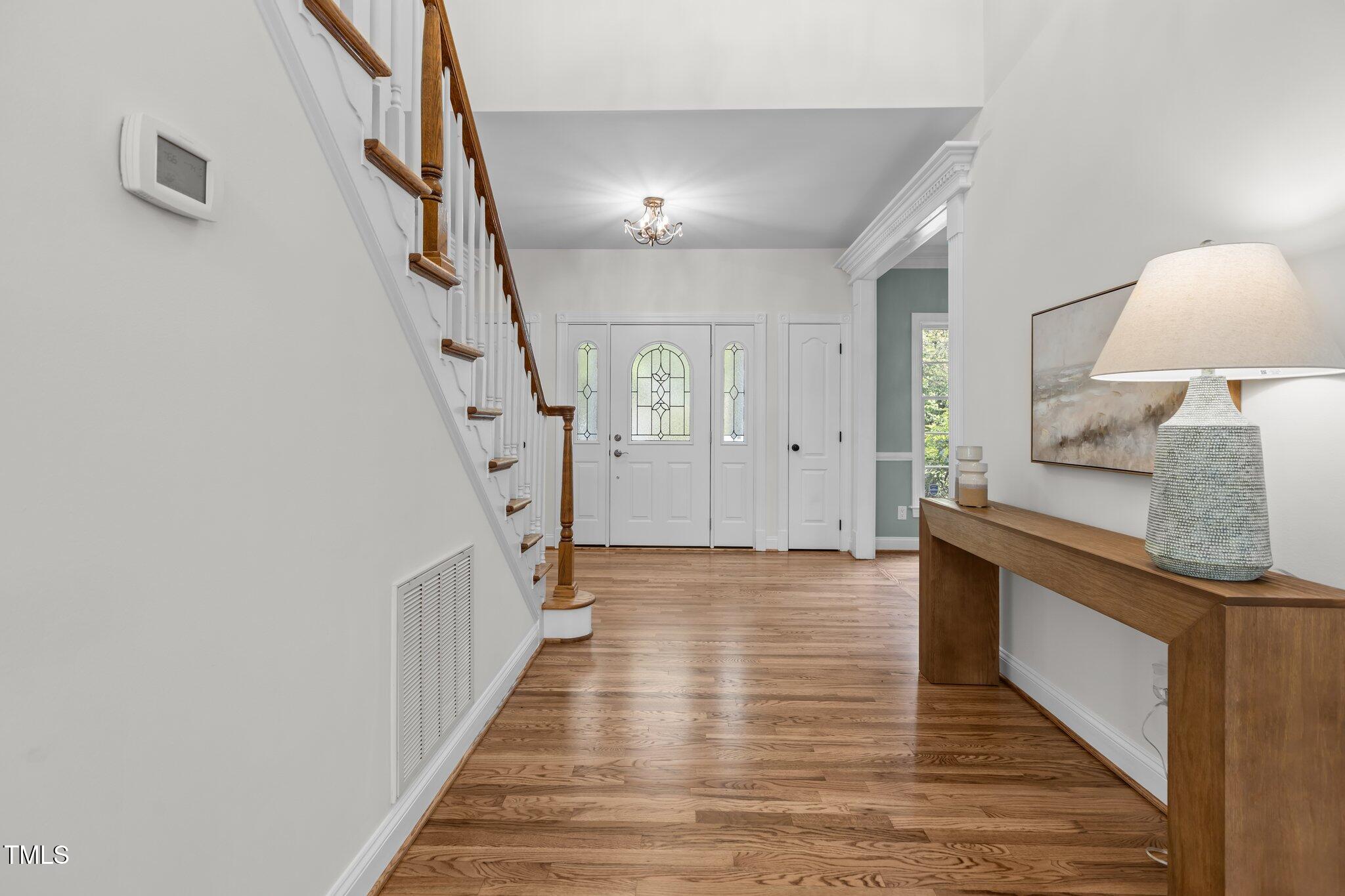 103 Ticonderoga Road Cary, NC 27519 - Photo 25 of 65 a view of a hallway with wooden floor and staircase