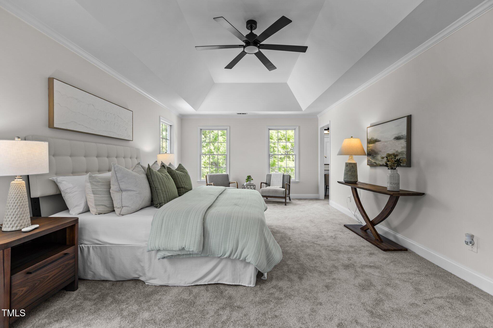 103 Ticonderoga Road Cary, NC 27519 - Photo 28 of 65 a bedroom with a bed a couch and a chandelier