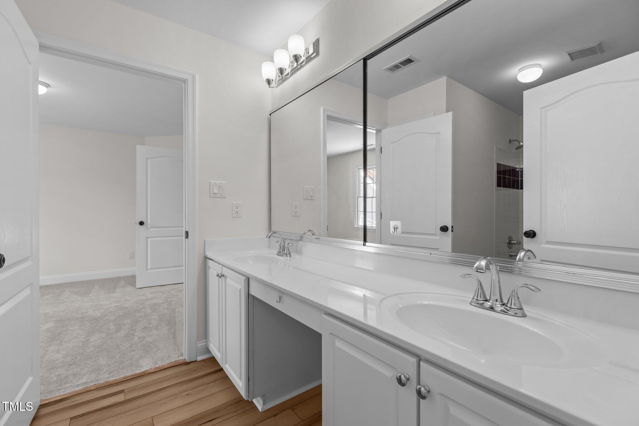 103 Ticonderoga Road Cary, NC 27519 - Photo 37 of 65 a bathroom with double sink and a mirror