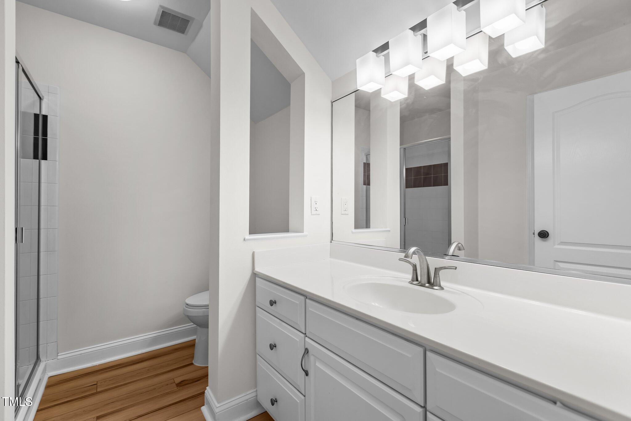 103 Ticonderoga Road Cary, NC 27519 - Photo 41 of 65 a bathroom with a sink a vanity and a mirror