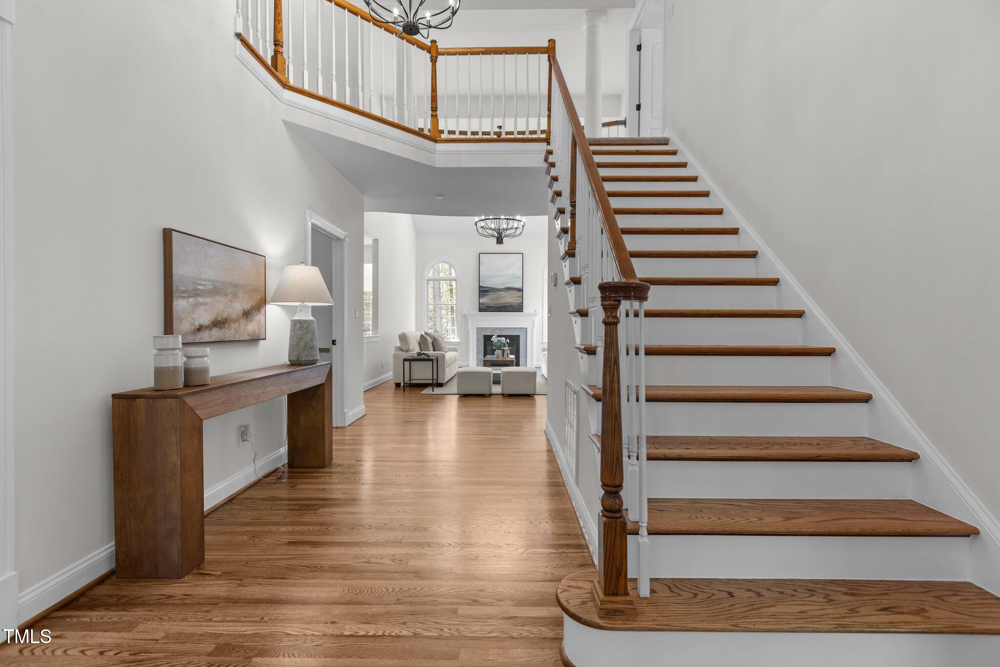 103 Ticonderoga Road Cary, NC 27519 - Photo 3 of 65 a view of entryway and hall with wooden floor