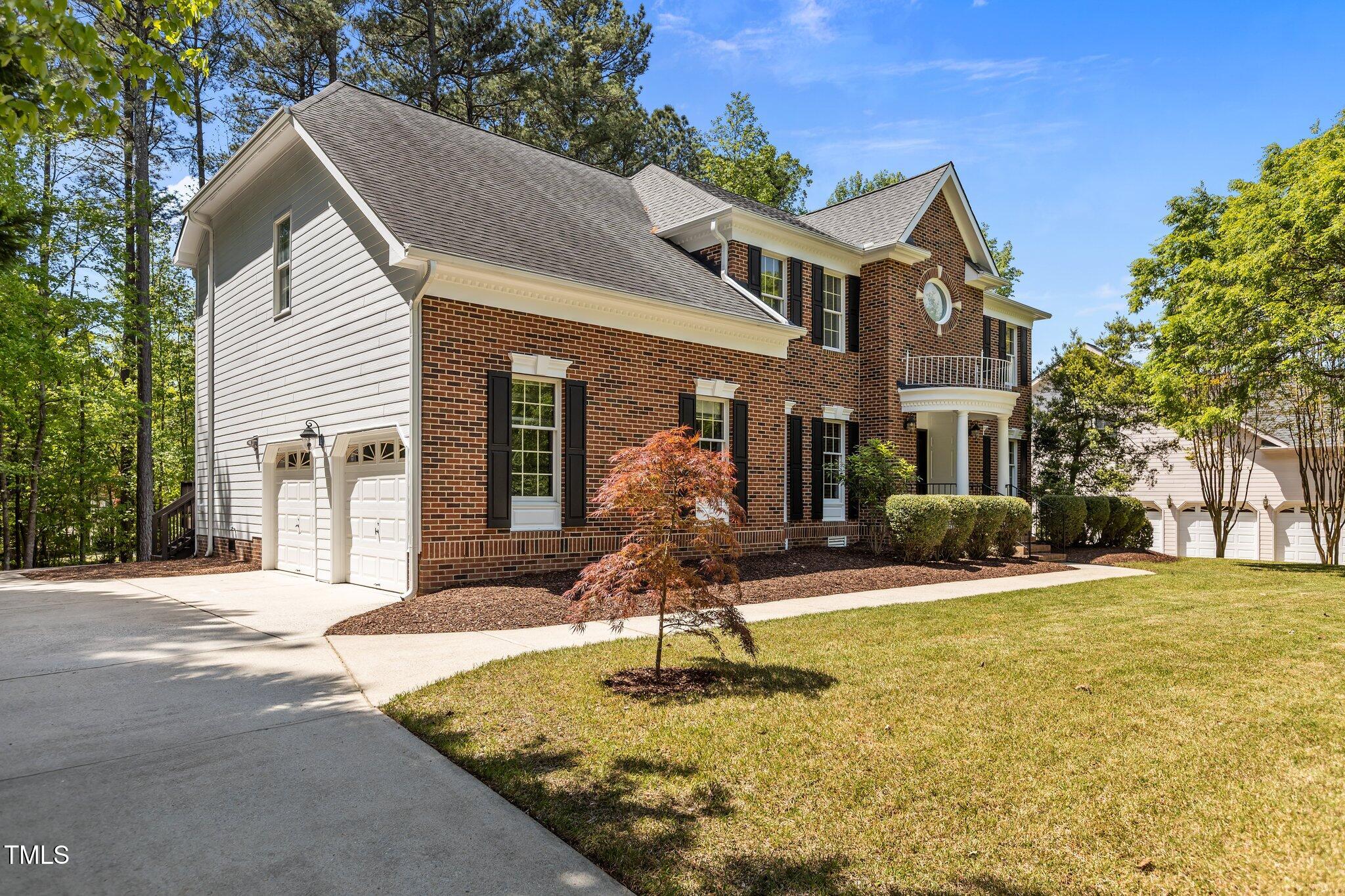 103 Ticonderoga Road Cary, NC 27519 - Photo 47 of 65 a front view of a house with garden