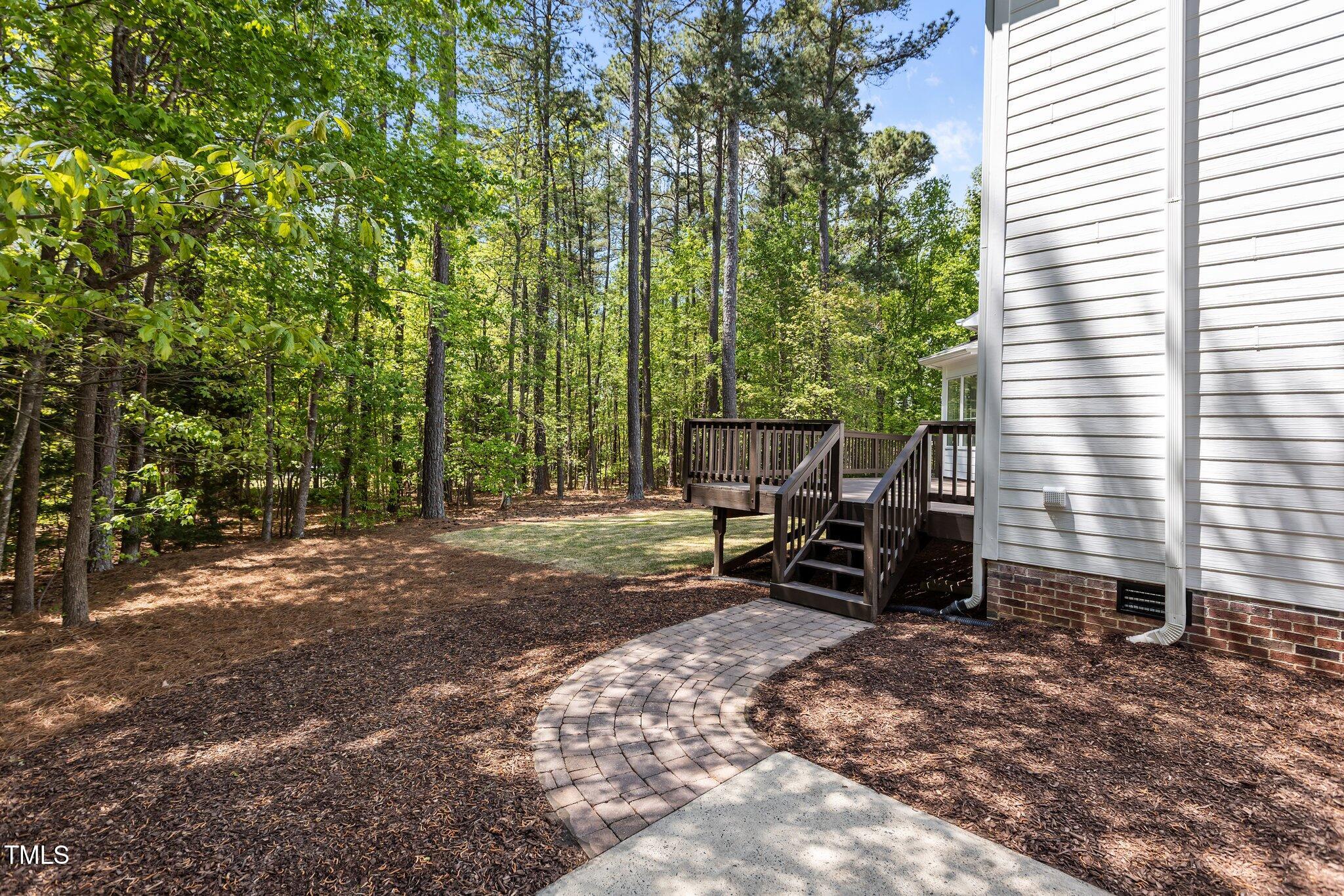 103 Ticonderoga Road Cary, NC 27519 - Photo 50 of 65 a view of a backyard with a table and chairs