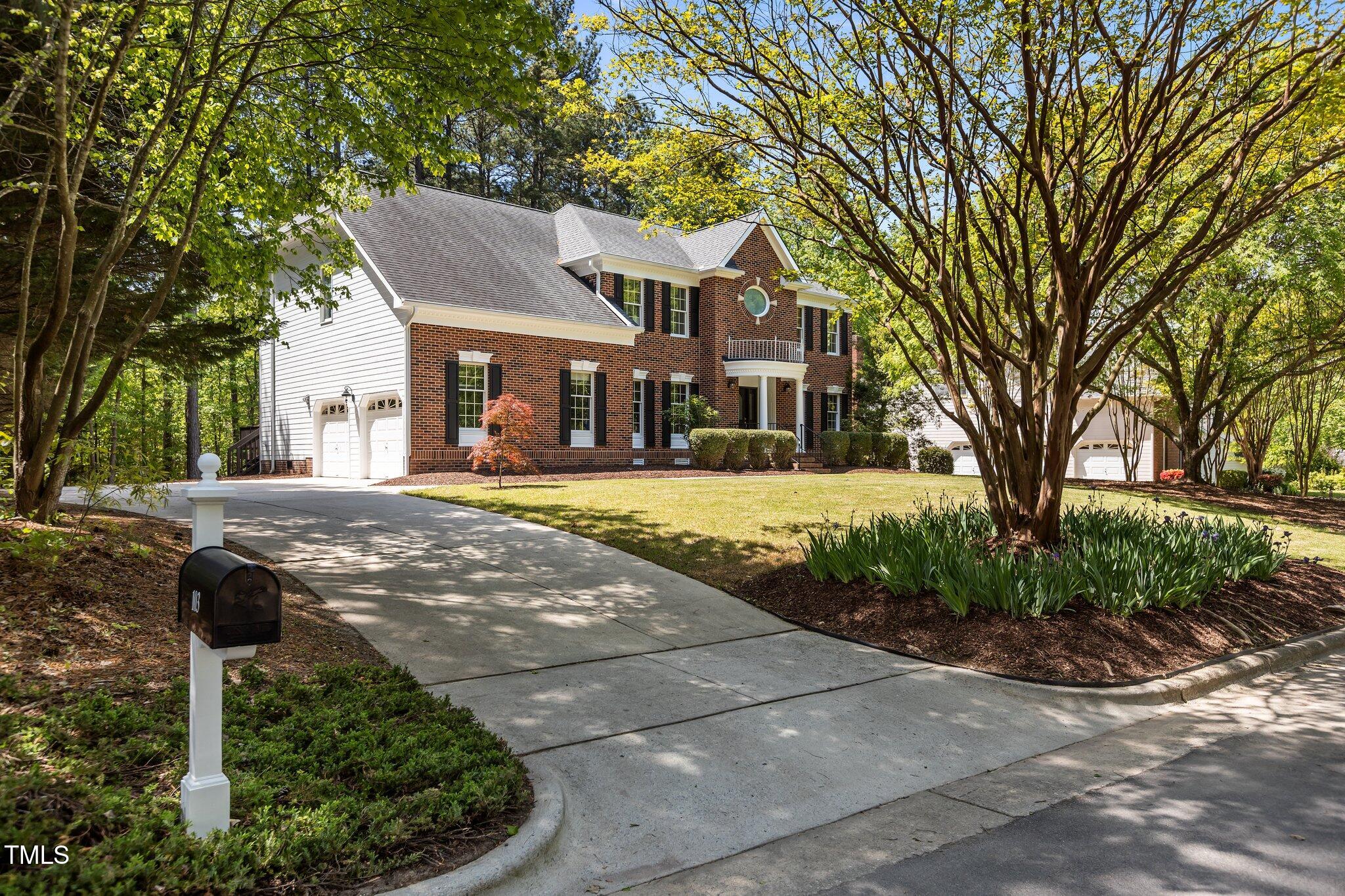 103 Ticonderoga Road Cary, NC 27519 - Photo 52 of 65 a front view of a house with a yard and palm trees